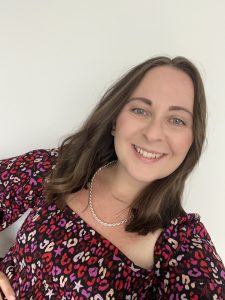 Personal Stylist in red flowery top smiling 